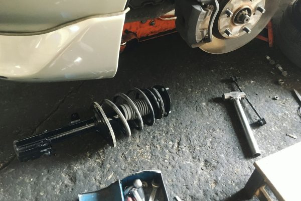 Car suspension, shock absorber and coil spring repair at the garage